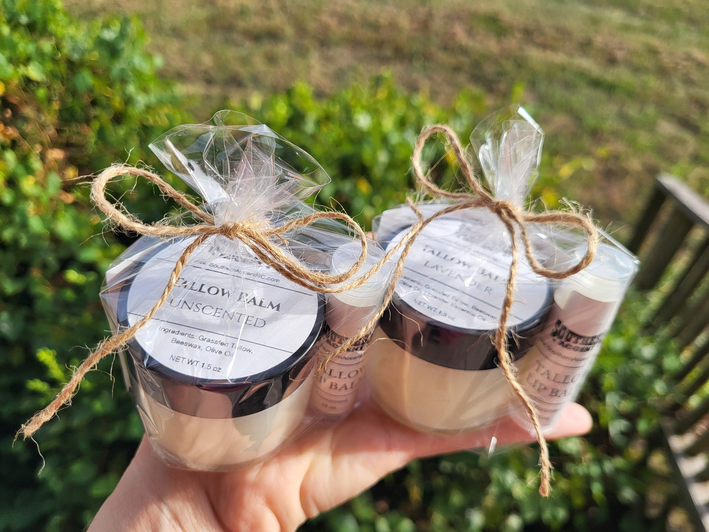 Two best seller southern accent tallow balm and lip balm bundles gift wrapped being held in a hand with a natural background