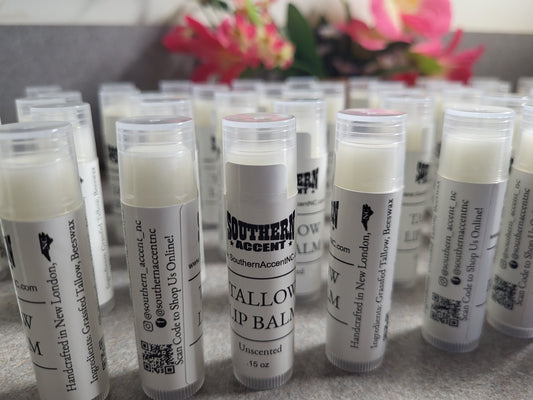 Multiple tallow p balms with visible Southern Accent branding on a clean surface with floral elements in the background.
