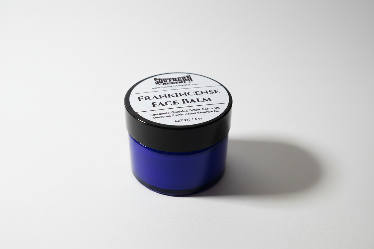 Blue jar of Southern Accent Frankincense Face Balm with black lid on a white background