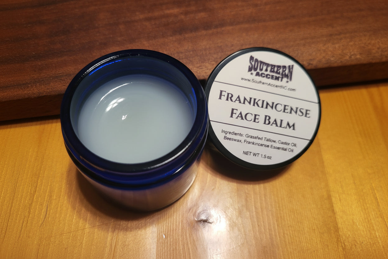 Open jar of creamy Southern Accent Frankincense Face Balm with label on a cedar and walnut wooden surface